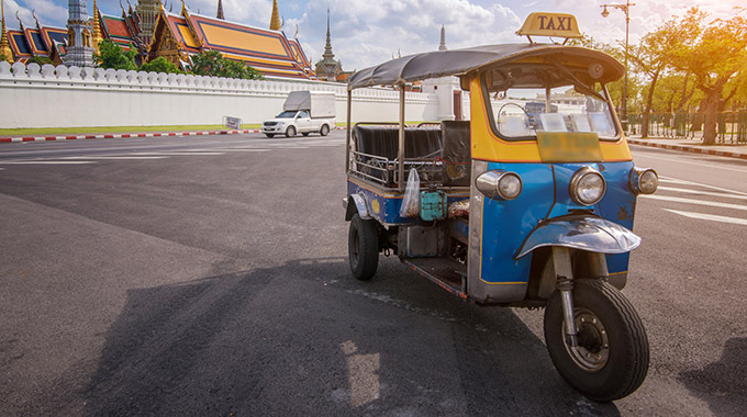 A tuk-tuk parked outside the Grand Palace in Bangkok