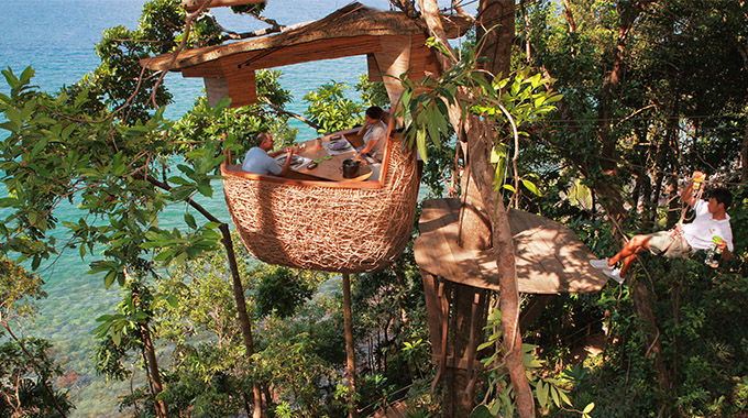 Why yes, that is a zip-lining waiter. And if you book his services at Soneva Kiri, he’ll deliver locally sourced delicacies to your bamboo tree pod in an ancient, seaside rain forest. | Photo courtesy Soneva Kiri