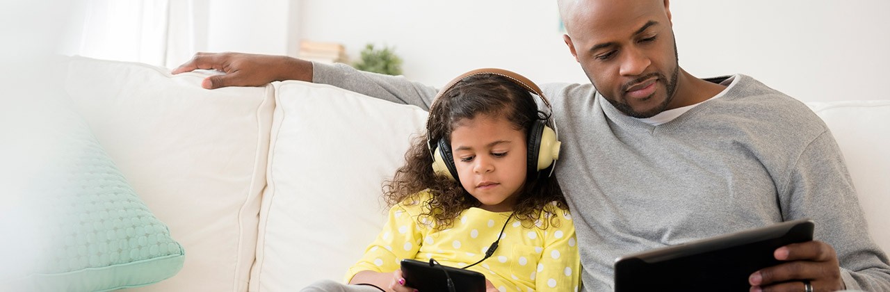 Father daughter streaming tablet phone couch