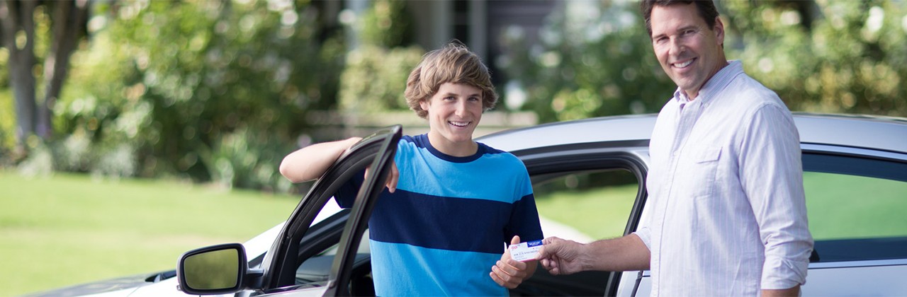 Teen poses with his new AAA membership card as he gets ready to drive