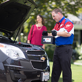 Person from AAA Mobile Battery Service replacing a car battery