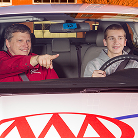 Teen behind the wheel with a AAA driving instructor