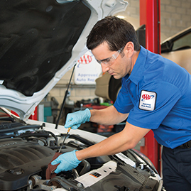 Mechanic checking car's oil level