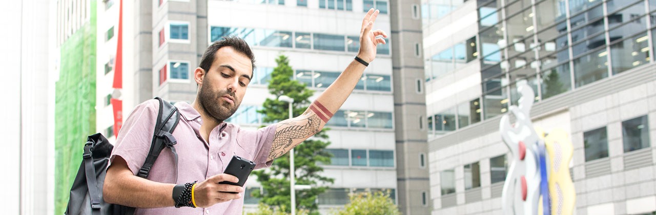 A man hails a ride-hailing car with a phone