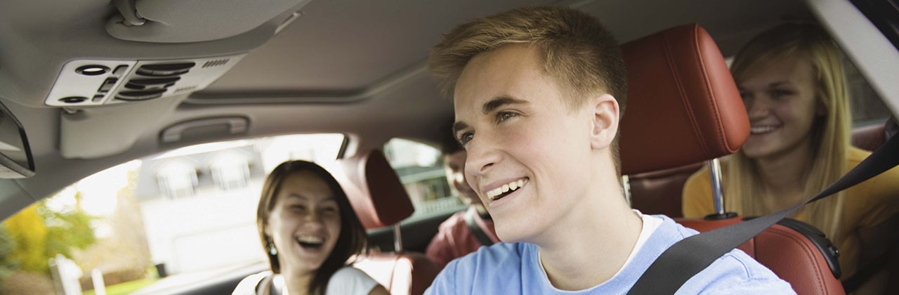 A teen driver behind the wheel with 2 teen friends in the car