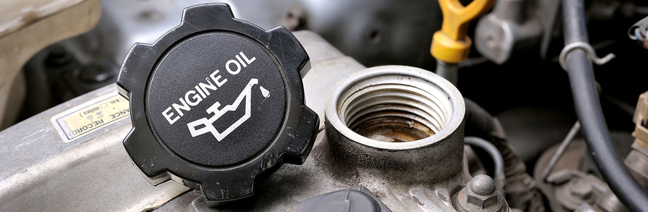 An unscrewed engine oil cap