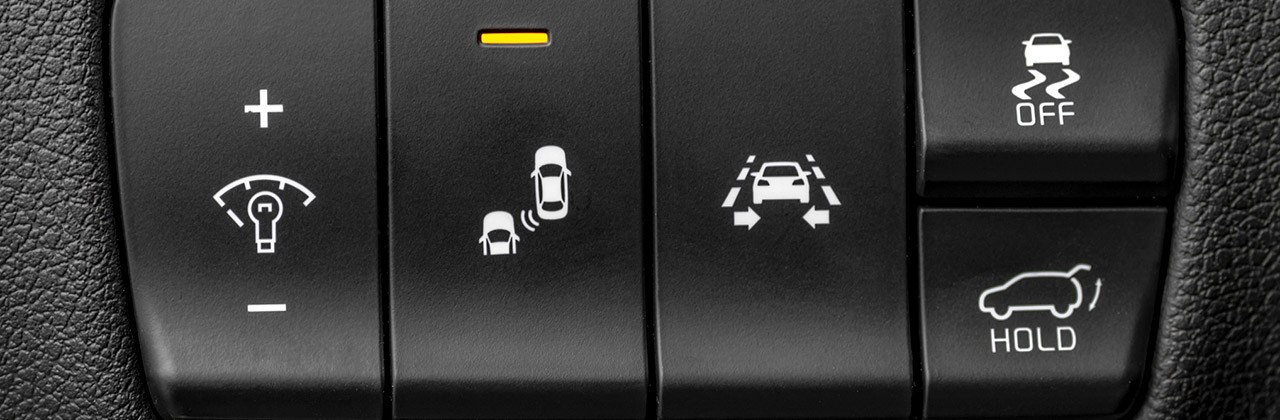Close up of switches for driver assistance technology on car dashboard