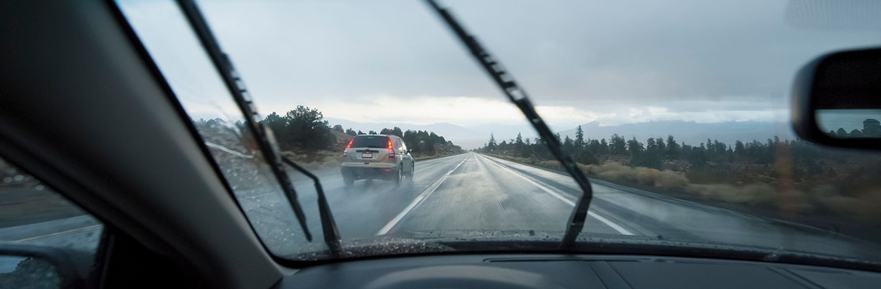 View from behind the windshield while driving in wet weather