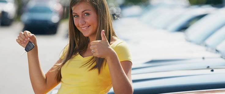 Woman holding key to new car Woman holding key to new car