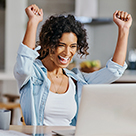 Happy woman looking at laptop