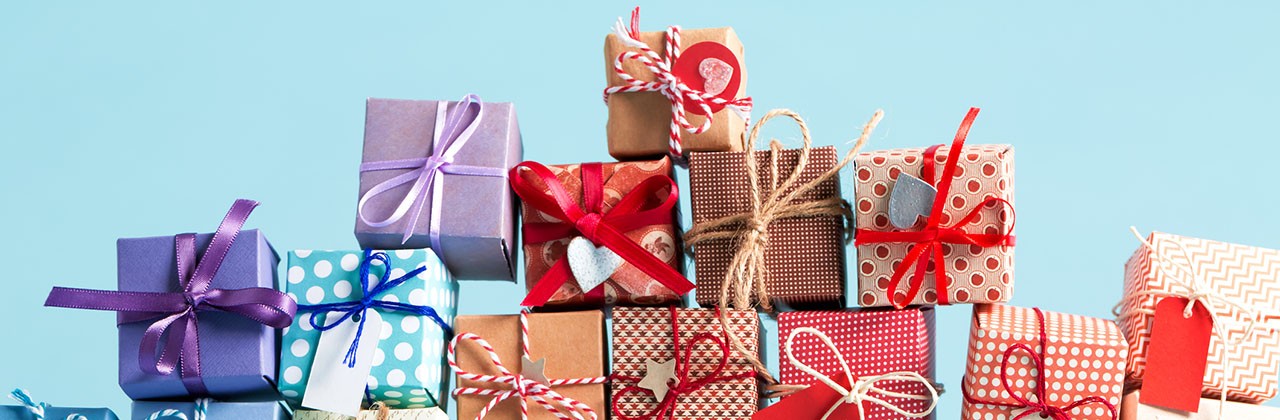 Different-colored gift boxes stacked in a pile