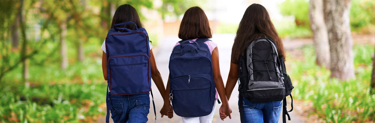 School girls backpacks walking
