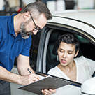 Mechanic reviewing bill with customer