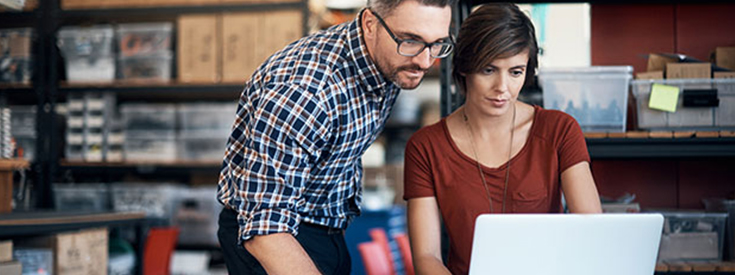 Two small business owners working on a computer