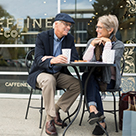Older couple having coffee outside
