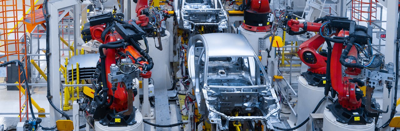 Assembly line production of new car. Automated welding of car body on production line. robotic arm on car production line is working