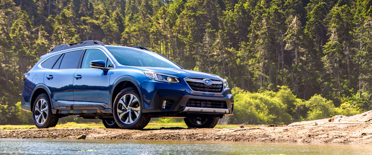 2020 Subaru Outback by the lake and forest.