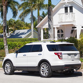 Cars parked on a street with palm trees in the city of Naples. Florida, United States