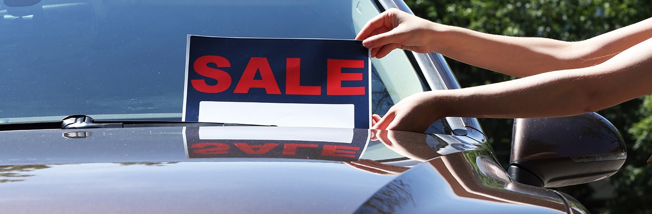 For sale sign on windshield of car