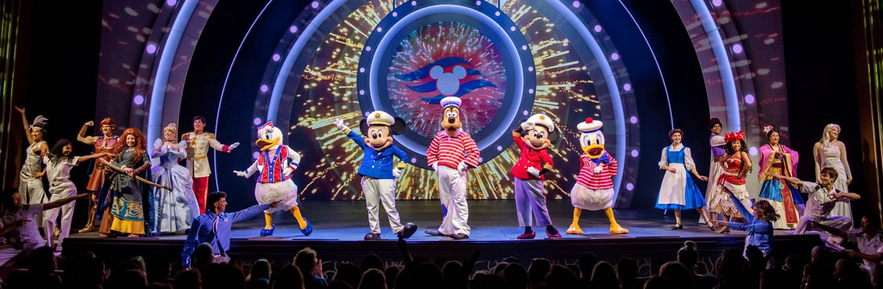 Mickey Mouse, Goofy, Minnie Mouse, and other Disney characters onstage aboard the Disney Wish