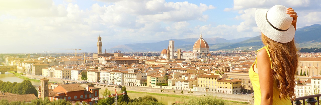 Beautiful woman in the city of Florence birthplace of the Renaissance. Panoramic banner with pretty girl enjoying view of Florence city in Tuscany, Italy.