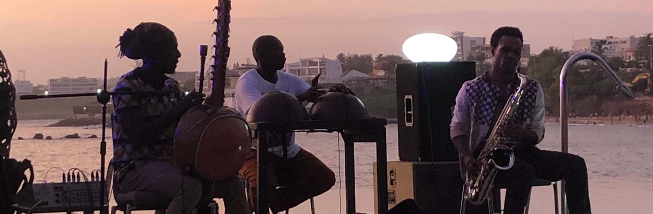 A trio performs poolside in Dakar, Senegal.