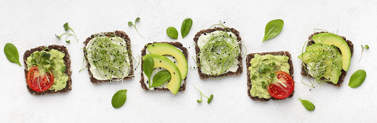 Set of vegetarian toast sandwiches with avocado, tofu, tomato and microgreen, top view, isolated on white, panorama