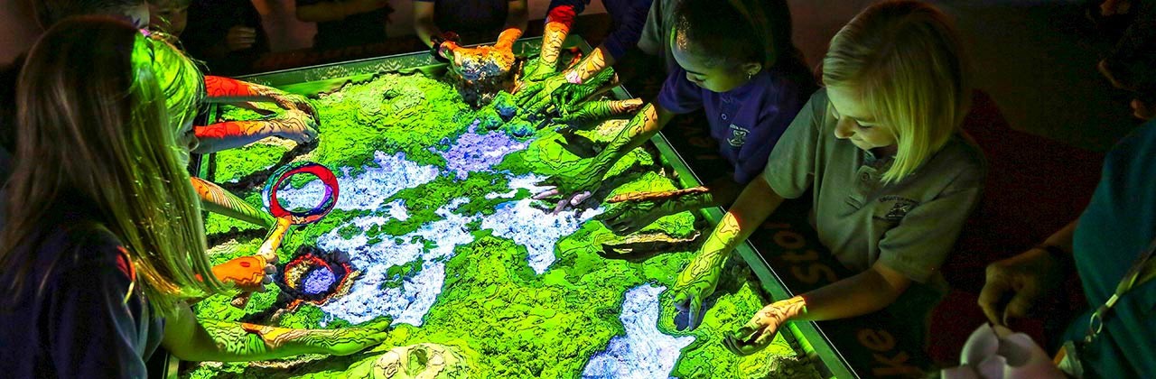 Kiddos enjoy hands-on fun at the kinetic sands table at the Cook Museum of Natural Science. | Photo courtesy Cook Museum of Natural Science