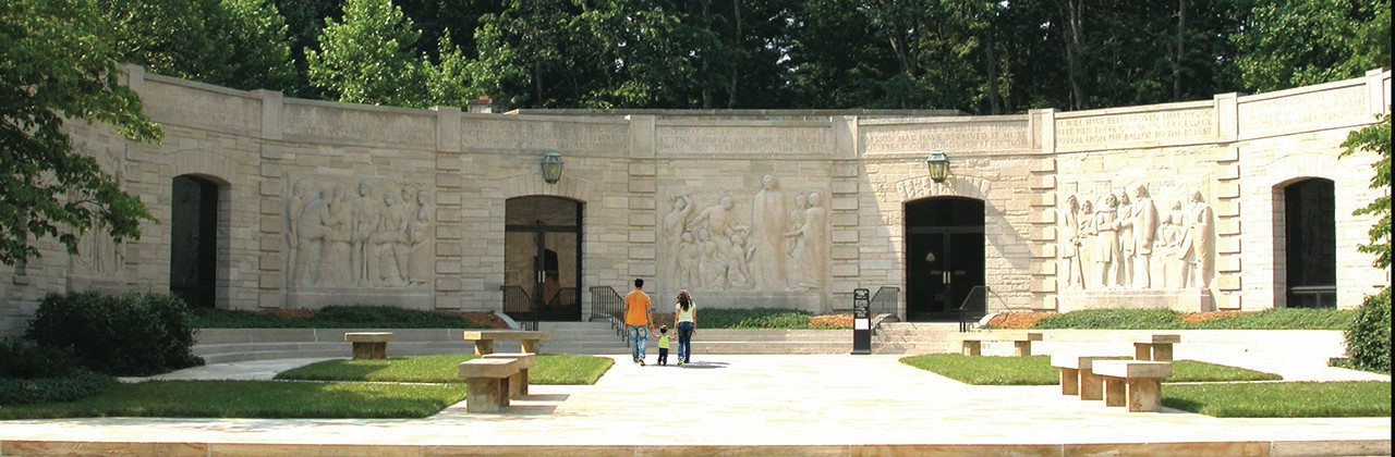 Relief sculptures depicting significant periods of Lincoln’s life adorn the exterior of the memorial