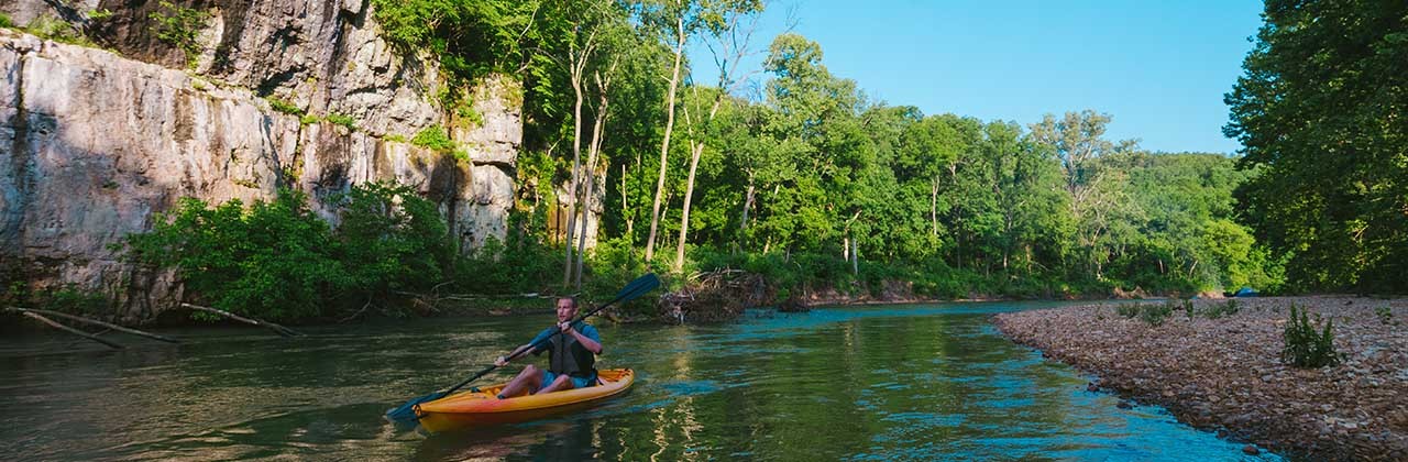 Current River in Ozark National Scenic Riverways | A kayaker navigates down the Current River. | Photo courtesy Missouri Division of Tourism