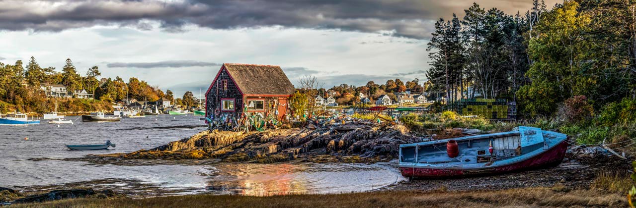 Fishing boats, a lobster shack, and scattered trap floats fill the harbor scene at Mackerel Cove on Bailey Island. | Photo by Kenneth Keifer/stock.adobe.com