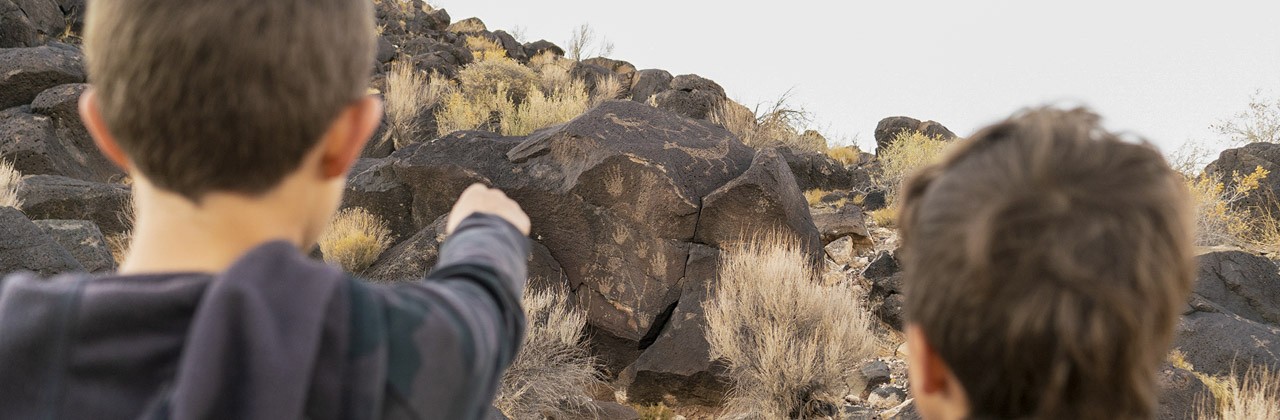 Ancient Puebloan art carved into basalt boulders on Piedras Marcadas Canyon Trail