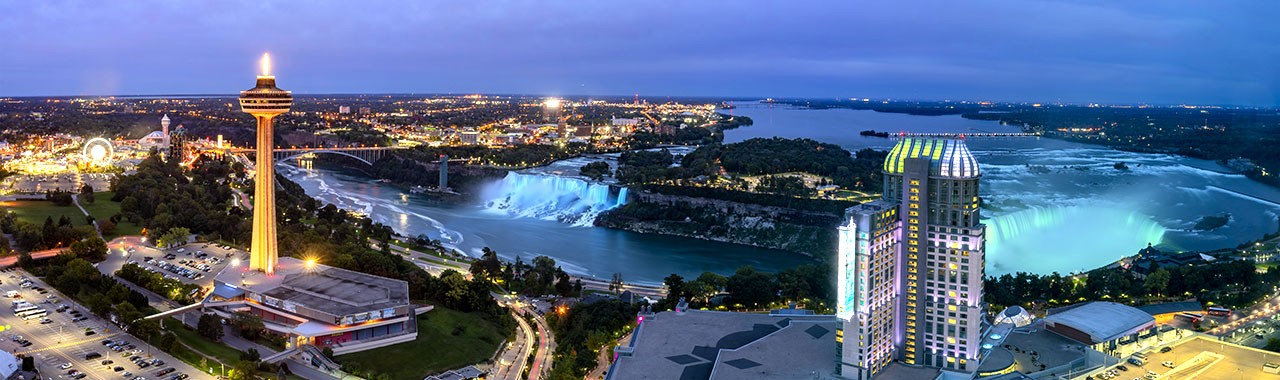 Night aerial view of the Skylon Tower and the beautiful Niagara Falls at Canada