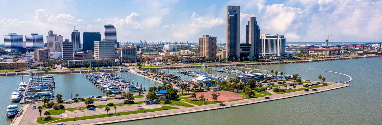Corpus Christi ocean drive. Corpus Christi City Skyline at Day in Texas - Cityscape. Panorama aerial view with skylines and marina piers row of boat, sailboat and yacht