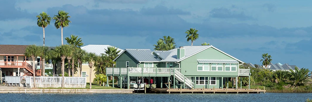 Residential houses encroaching venerable wetlands in upper Gulf coast. Aransas National Wildlife Refuge, Texas, USA.