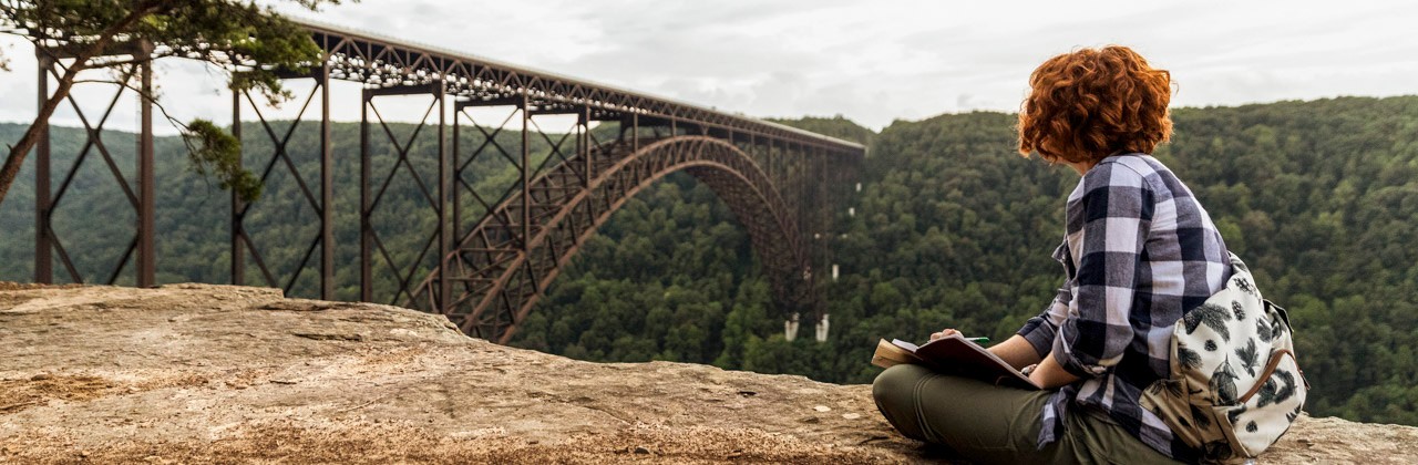 A visitor enjoys the view at the New River Gorge Bridge