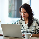 Woman using laptop at home