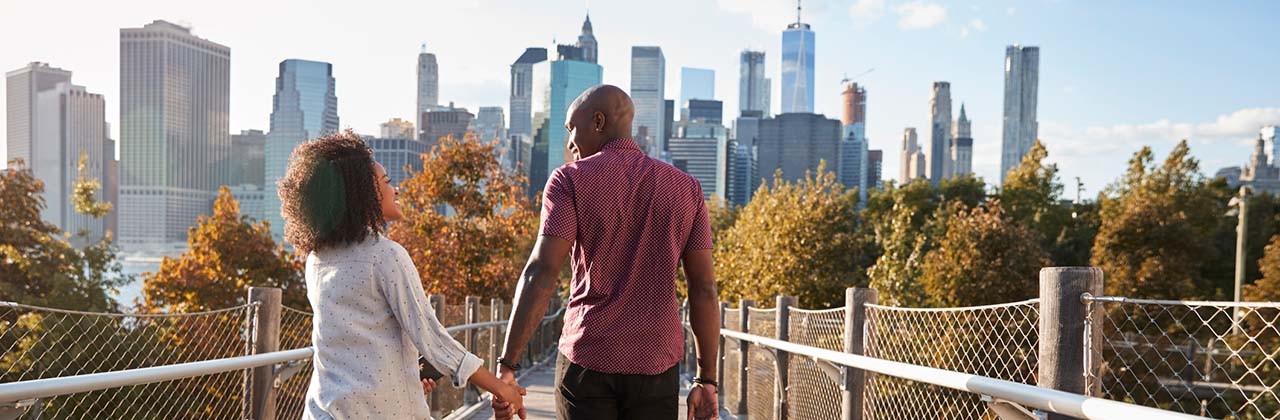 A couple holding hands while visiting New York City