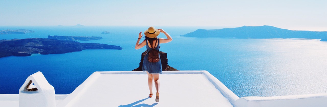 Woman looking out at the sea from the Greek island of Santorini