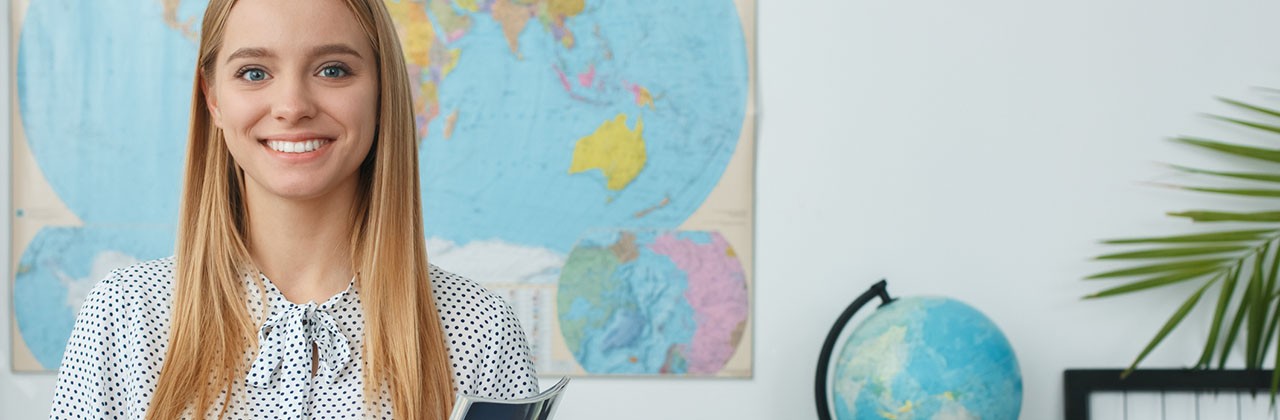 A young woman travel agent in her office