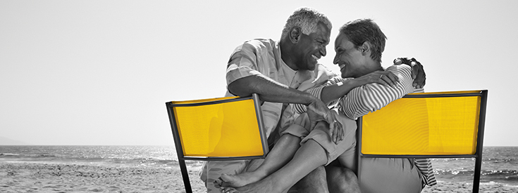 Couple sitting in chairs on beach