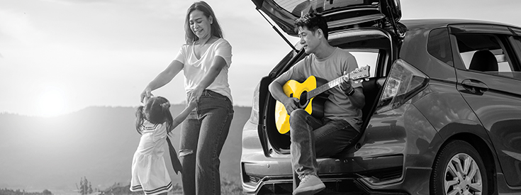 Father playing guitar while family dances