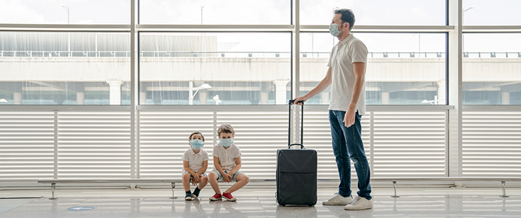 Man and children wearing masks at airport Man and children wearing masks at airport