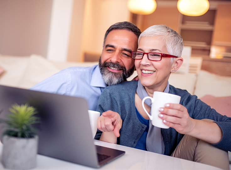Couple watching show on laptop Couple watching show on laptop