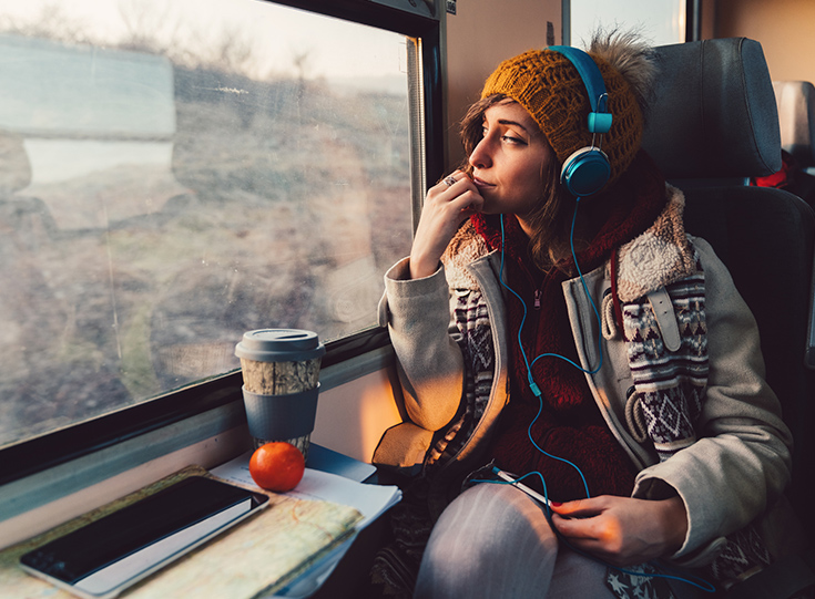 Woman on train Woman on train listening to headphones
