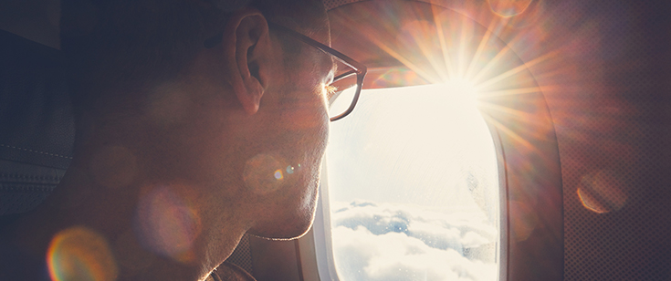 Man looking out of plane window