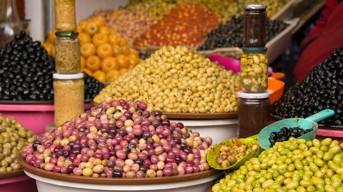 Large piles of olives for sale at a market in Morocco