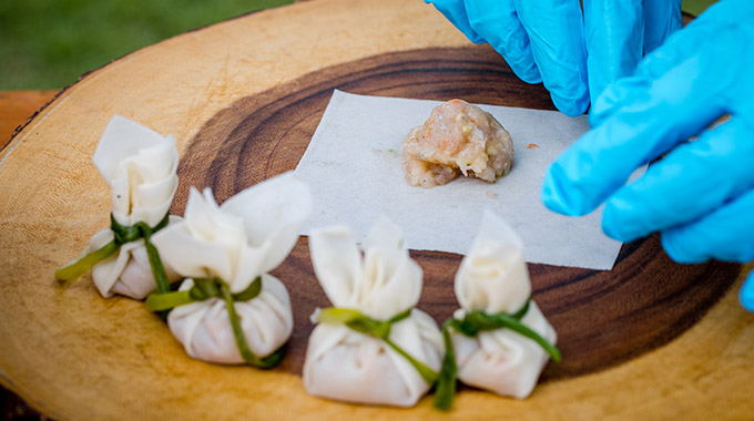 A person makes Thai dumplings in a cooking class