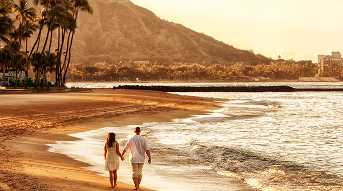 A couple walking on Waikiki Beach in Honolulu, Hawai‘i