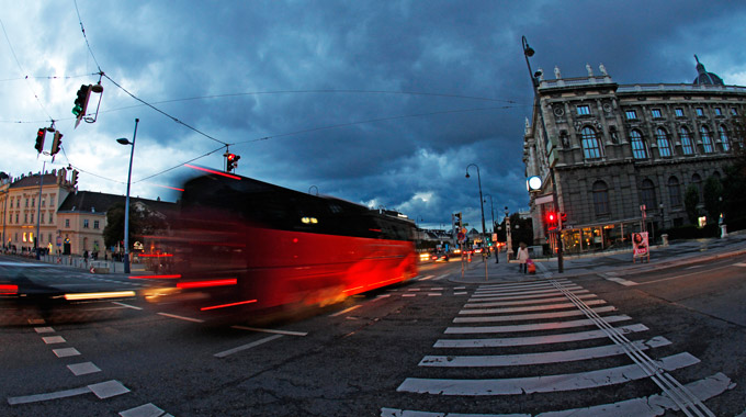 Charter bus passing through Vienna, Austria in the evening